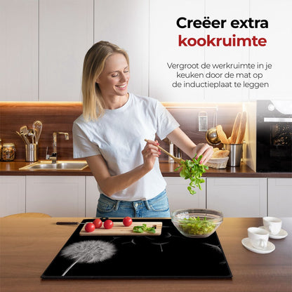 Vrouw in de keuken bezig met eten voorbereiden met behulp van de inductie beschermer paardenbloem